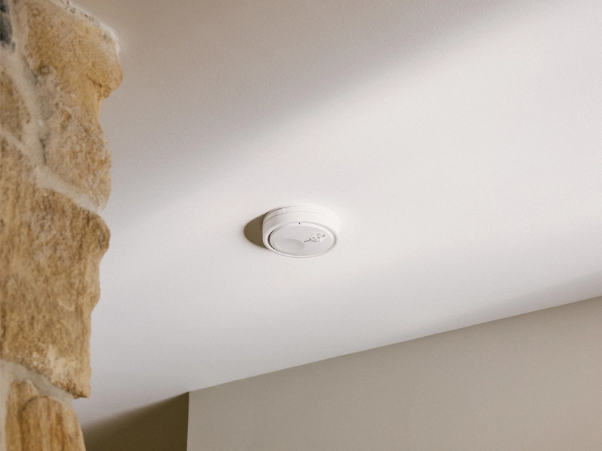 A new Clipsal Fire Tek Smoke Alarm product installed on a ceiling.