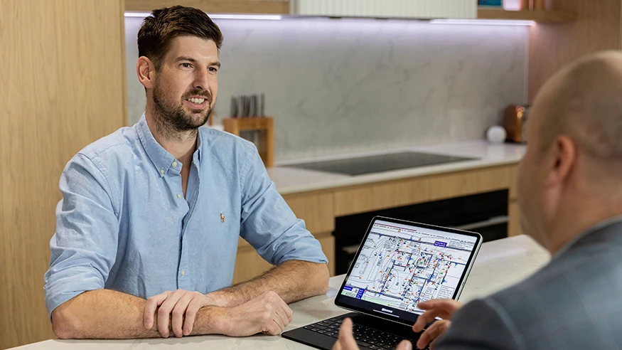 A designer conversing with a Clipsal Electric Home Design Service consultant.