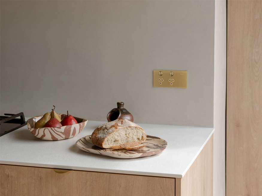 A Clipsal Solis T Series power point installed on a kitchen wall.