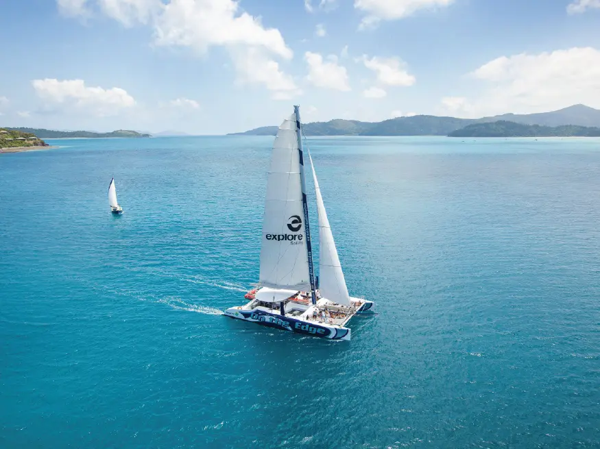 Sailboat on clear blue water.