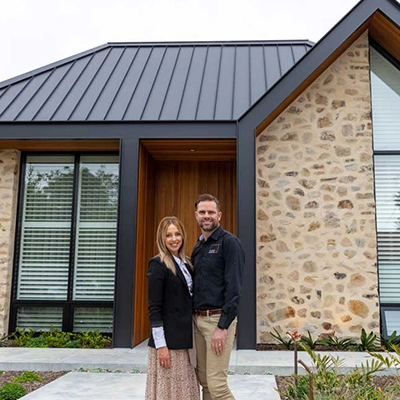 Builder Troy and interior designer Carmel from Klemm Homes standing in front of their house.