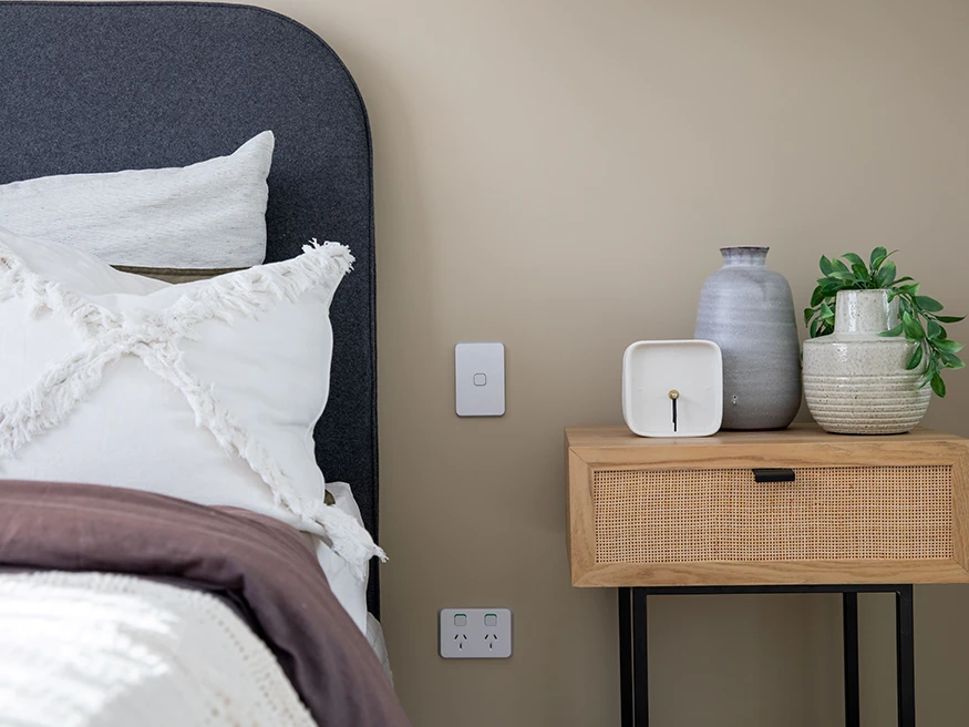 A minimalistic bedroom with Clipsal Iconic switches installed.
