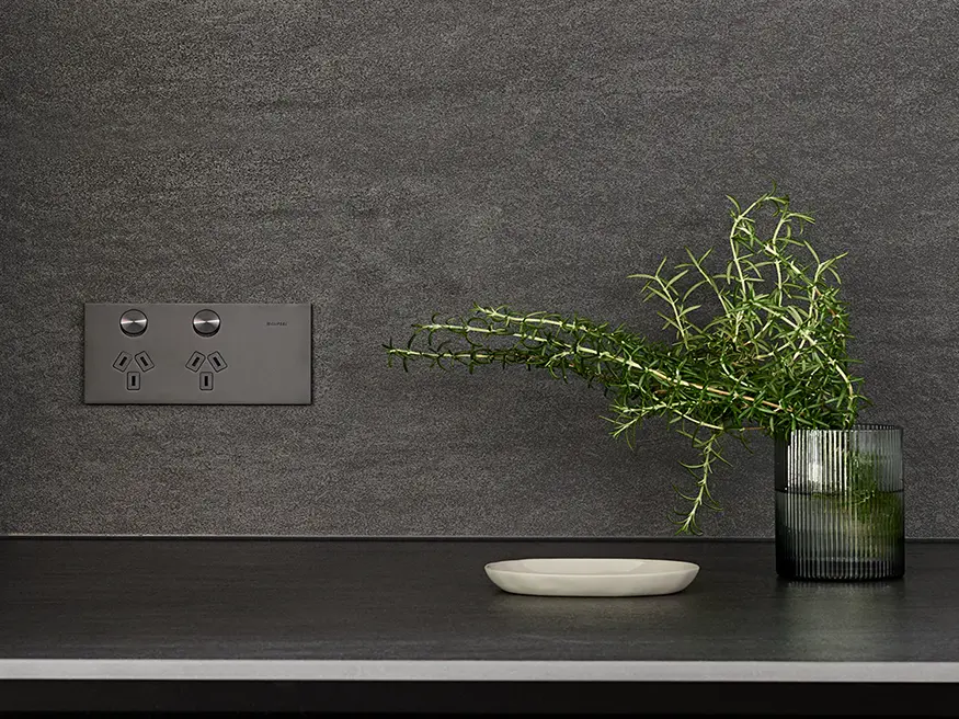 A Clipsal Solis T Series switch in Ebony Aluminium.