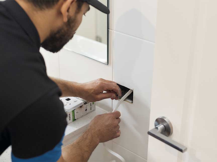 electrician with hole in wall