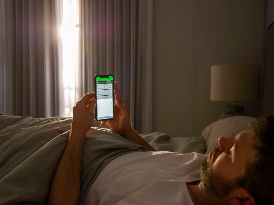 A homeowner using the Wiser by SE app on his smartphone.