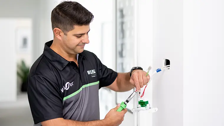 Electrician installing a switch.